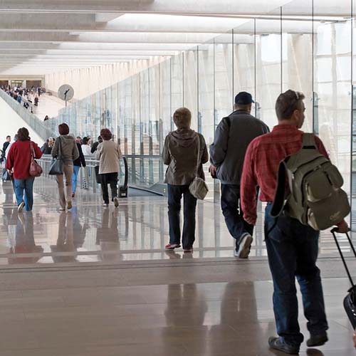 Travelers walking through an airport.