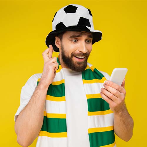 Sports fan reading a mobile sports alert on smartphone.